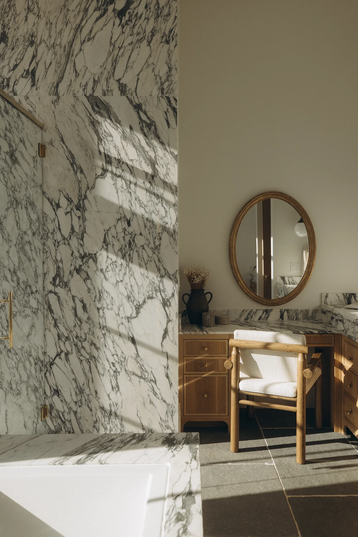 Primary bath with Arabescato marble shower wall and fluted oak vanity