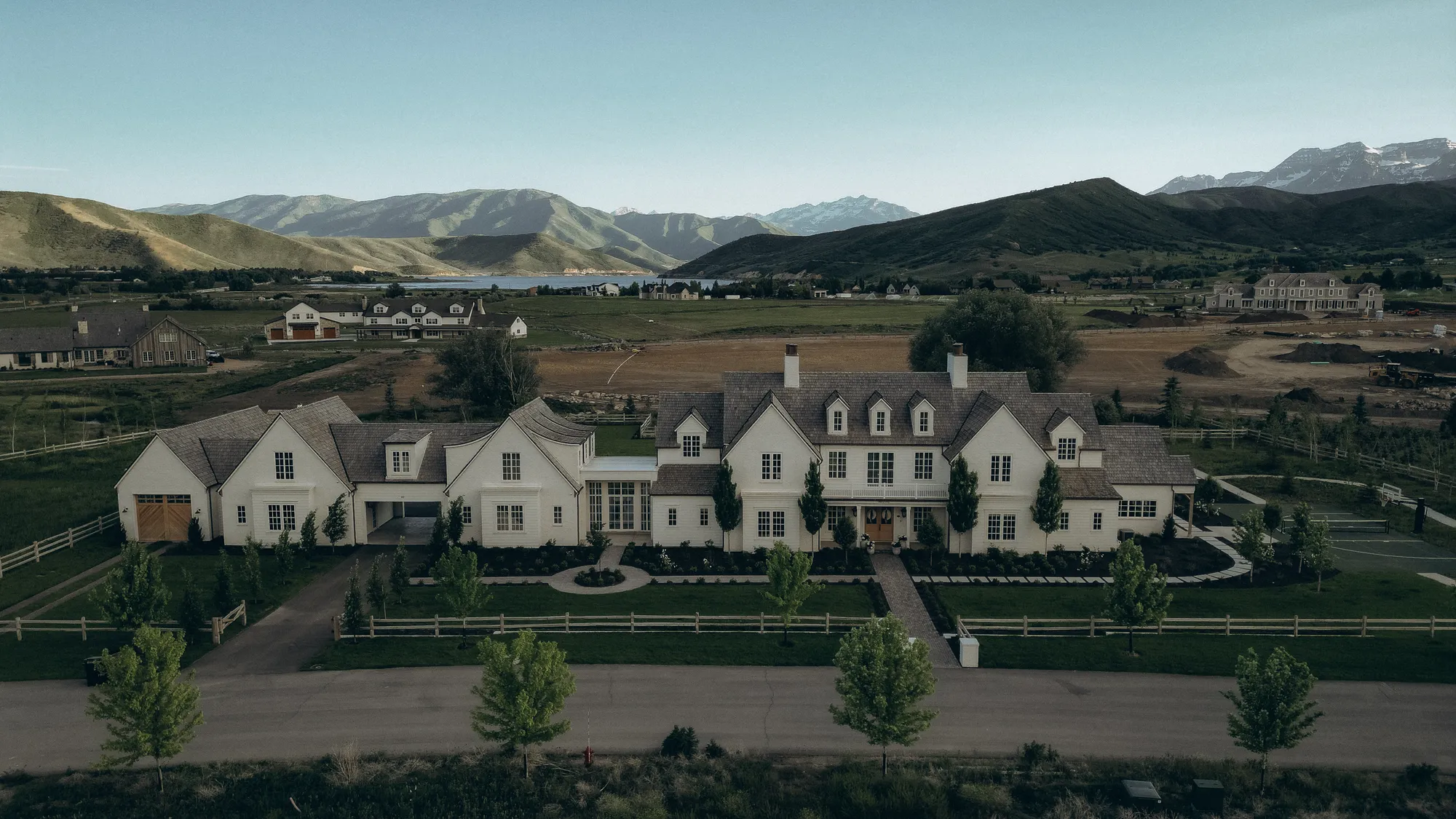 Aerial view of a Chatwin Homes estate above Deer Creek Reservoir with Wasatch peaks behind